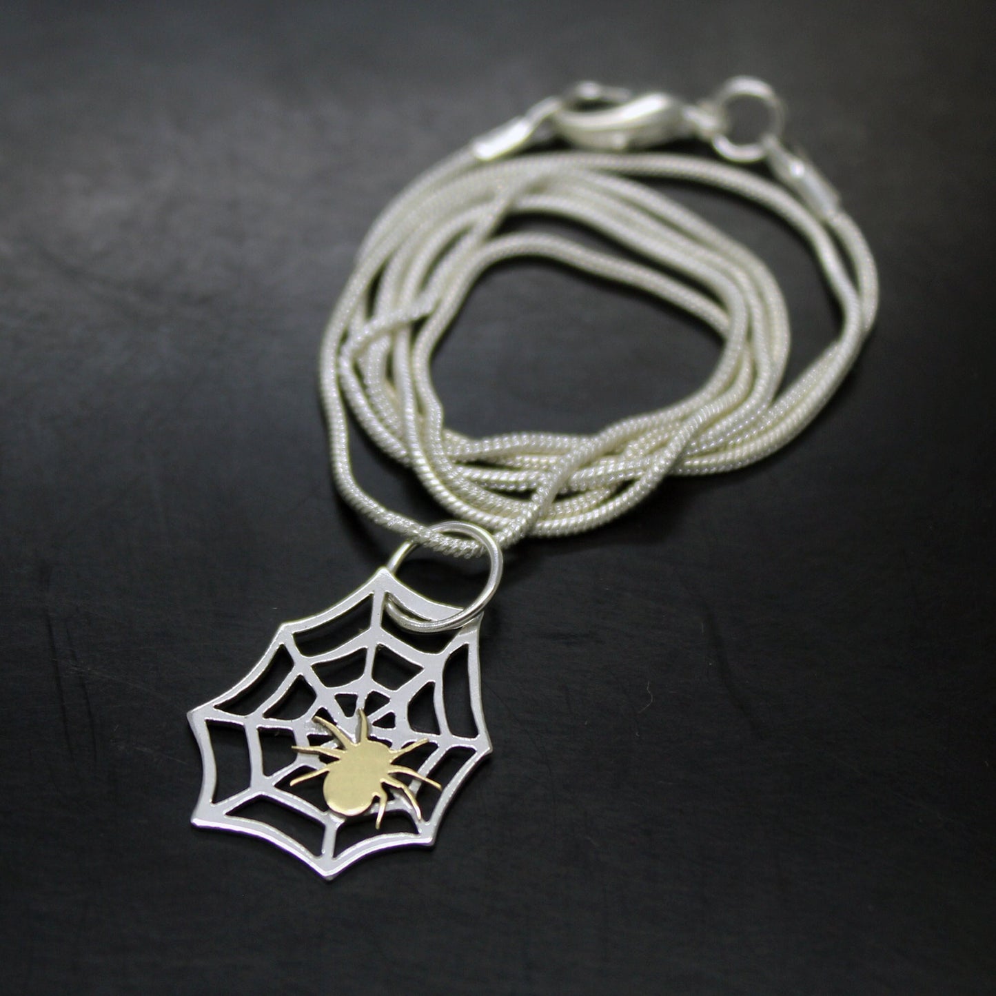 925 silver spider web pendant with brass spider