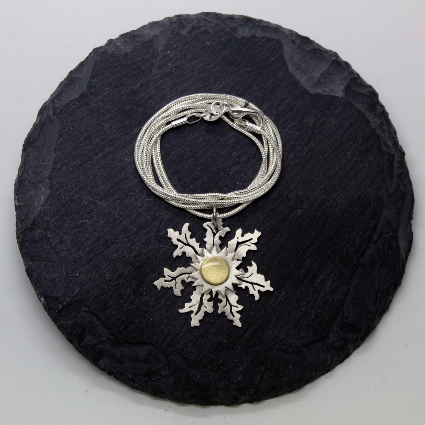 Eguzkilore pendant in 925 silver and brass