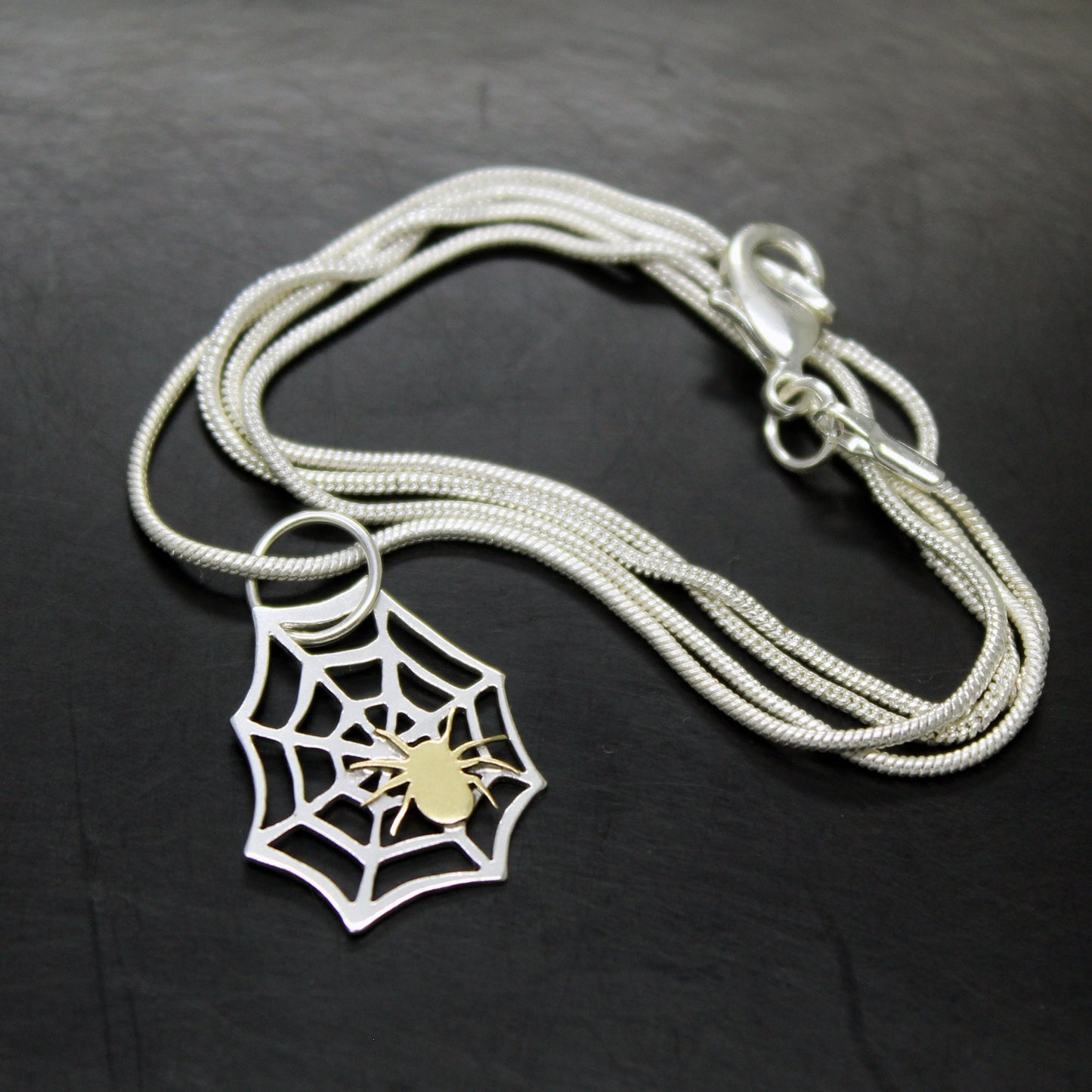 925 silver spider web pendant with brass spider